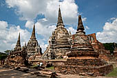 Ayutthaya, Thailand. Wat Phra Si Sanphet, the three spired chedi in background, the low ruins in the foreground are what remains of the surrounding gallery.